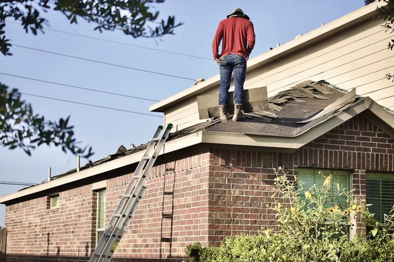 Professional roofer working on a residential roof in Cecil